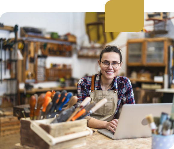 Smiling business owner in front of laptop