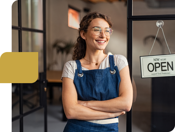 Smiling business owner with Open sign