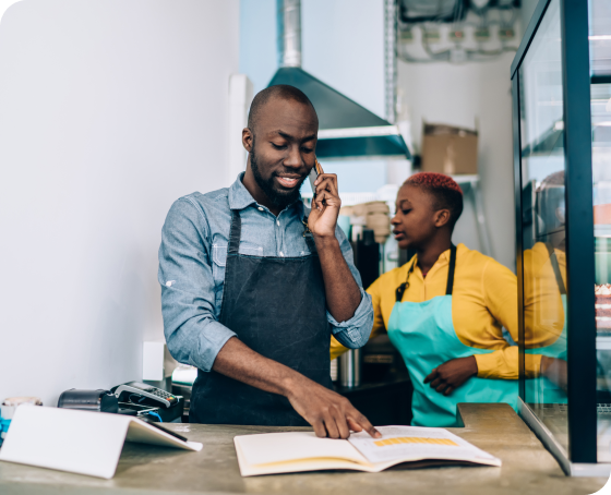 Business owner on phone near kitchen